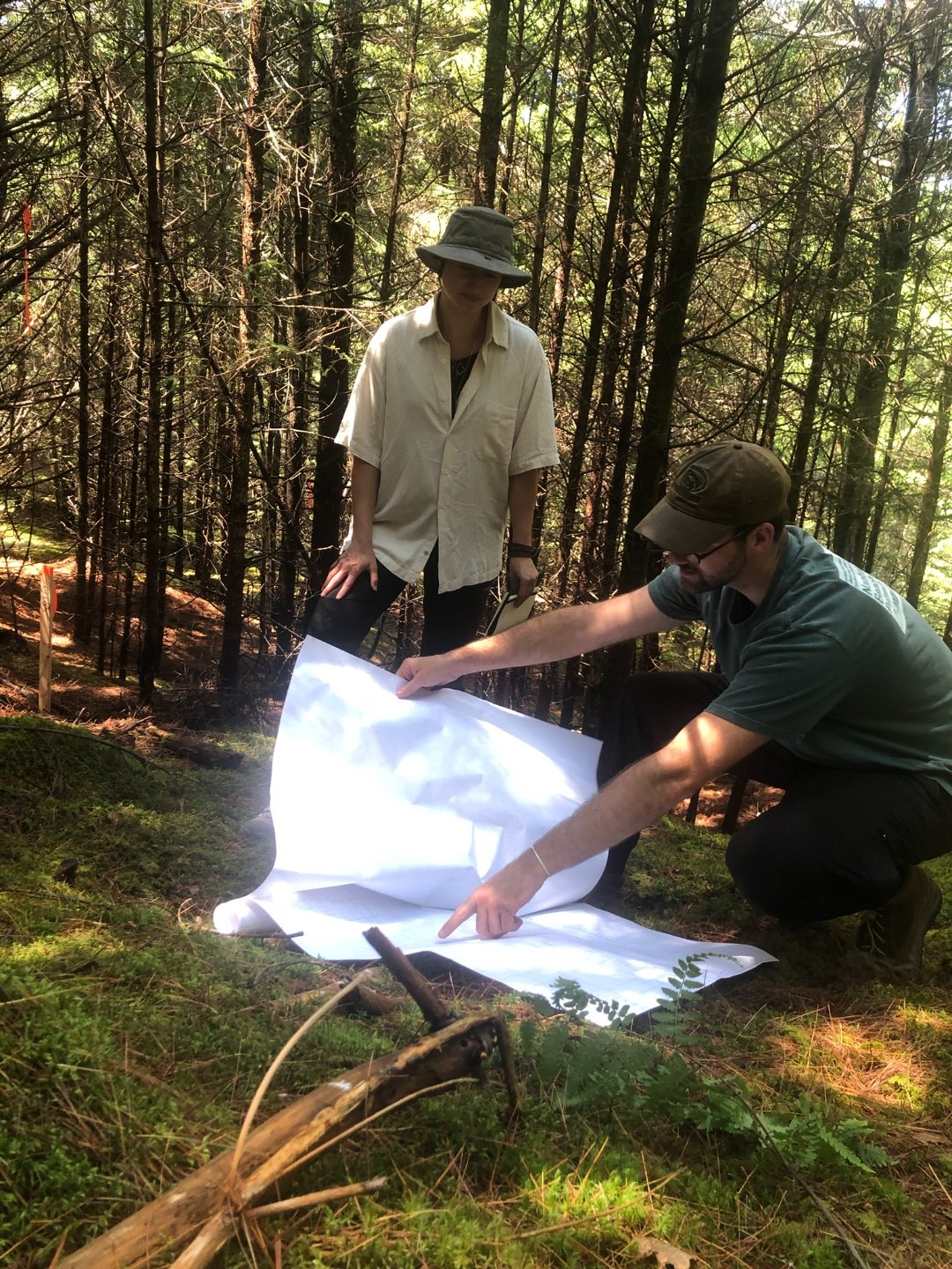 Glenn Group staff reviewing plans on site in the forest