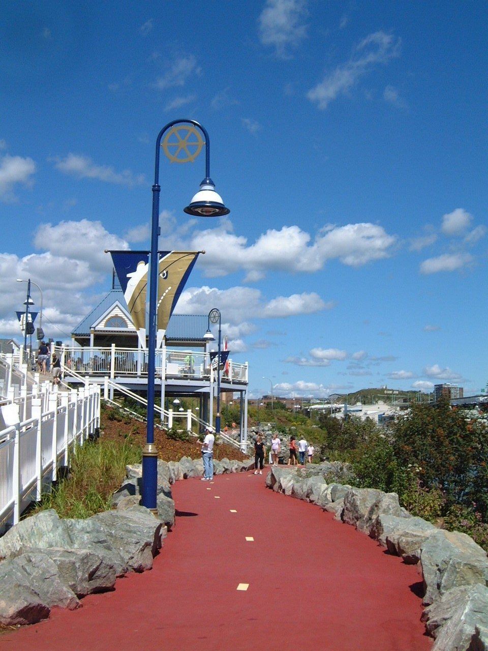 The signature red boardwalk of Harbour Passage with decorative street lighting