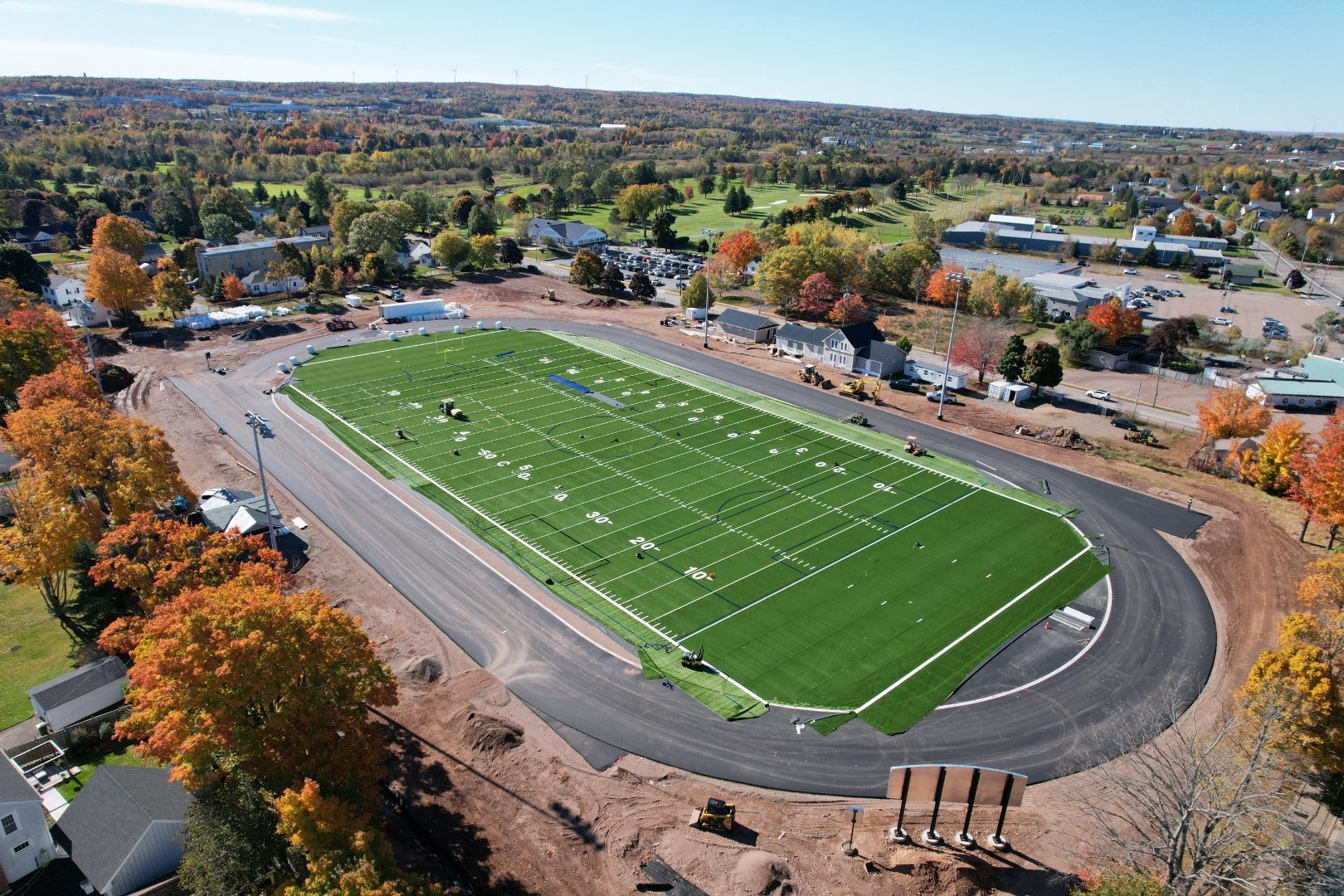 Aerial view of an athletic stadium and turf field designed by Glenn Group
