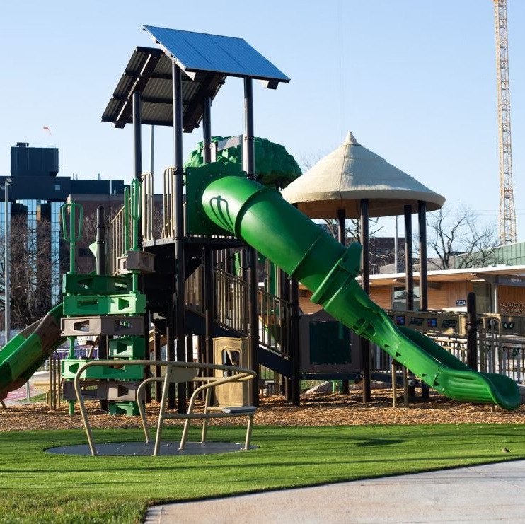 Green tube-slide structure with shade pavilion